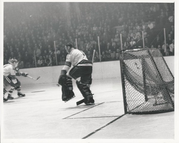 Photo of Stan Mikita scoring on Jacques Plant and the New York Rangers at Chicago Stadium. 
