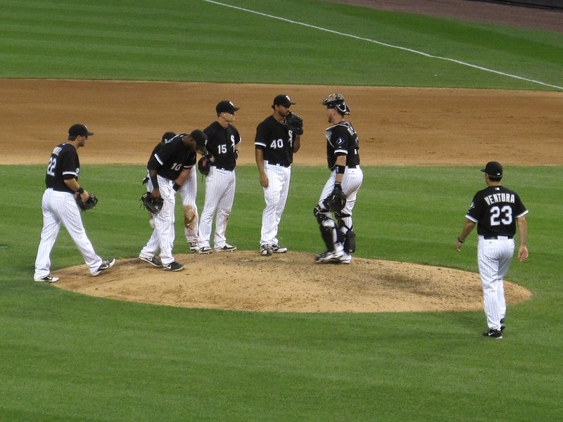Photo of Chicago White Sox players meeting together on the pitcher's mound of U.S. Cellular Field.