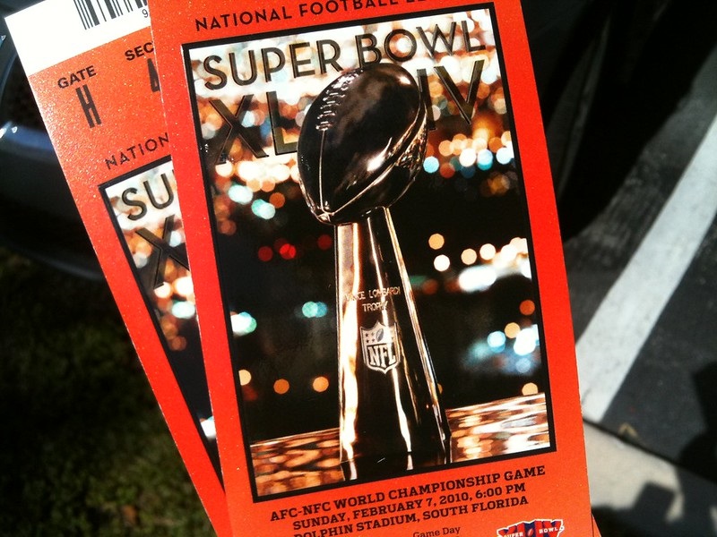 Photo of a sports fan holding Super Bowl tickets.