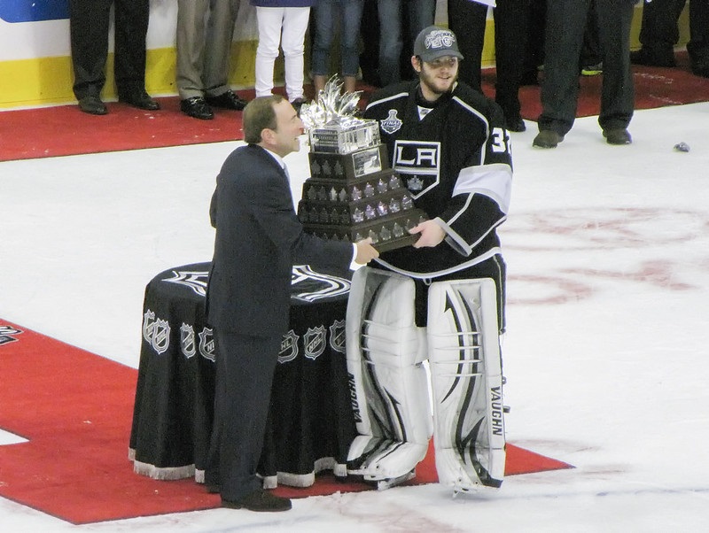 Photo of NHL commissioner handing the Stanley Cup championship trophy to Jonathan Quick.