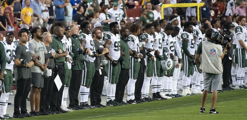 Photo of New York Jets players during the national anthem before kickoff.