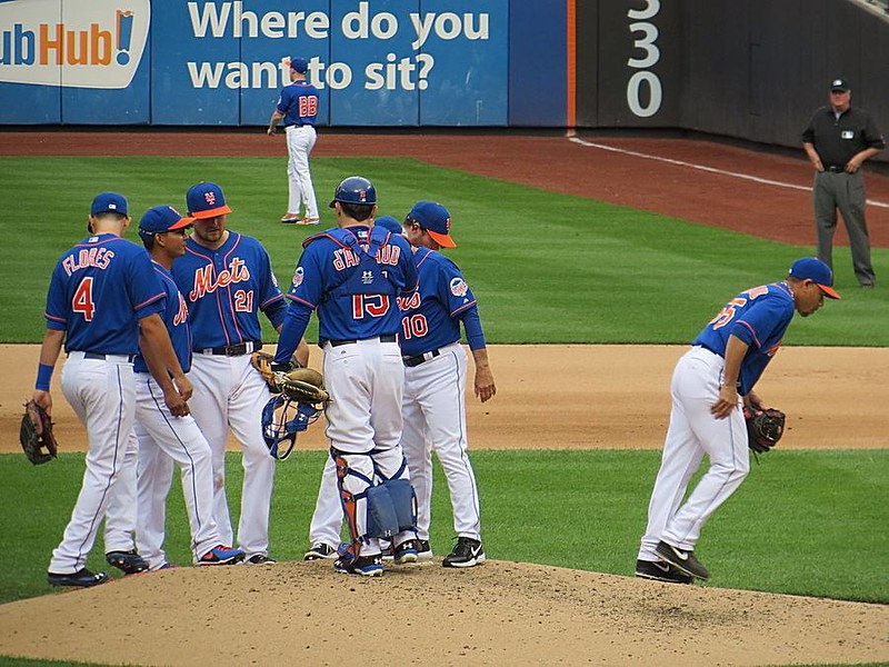 Photo of New York Mets players meeting on the pitcher's mound at Citi Field.