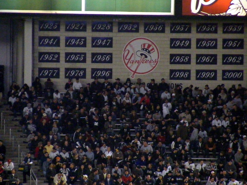 Photo of New York Yankees fans cheering in the bleachers at Yankee Stadium.