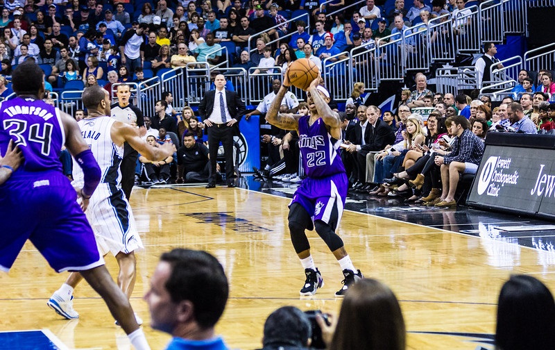 Photo of Sacramento Kings players on the court during a game versus the Orlando Magic.