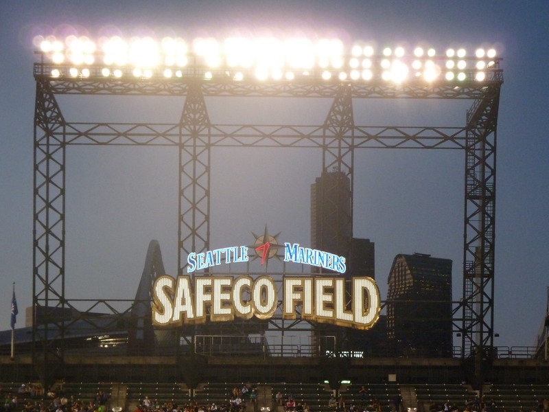 Photo of the Safeco Field outfield sign at night.