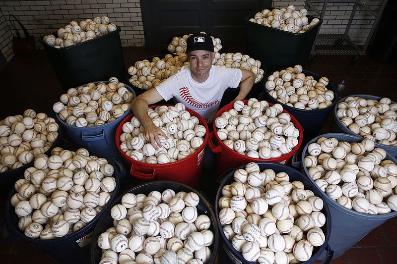 Photo of Zack Hample with his baseball collection. 