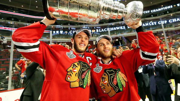 Photo of Patrick Kane and Jonathon Toews hoisting the Stanley Cup.