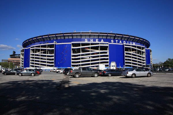 Photo of Shea Stadium from the parking lot with Citi Field in the background.