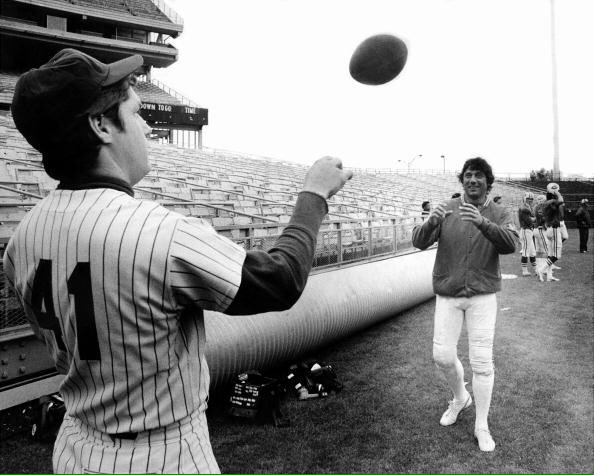 Photo of New York Mets pitcher Tom Seaver playing catch with New York Jets Quarterback Joe Namath.