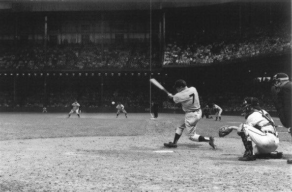 Photo of New York Yankee Mickey Mantle hammering a home run at Tiger Stadium.