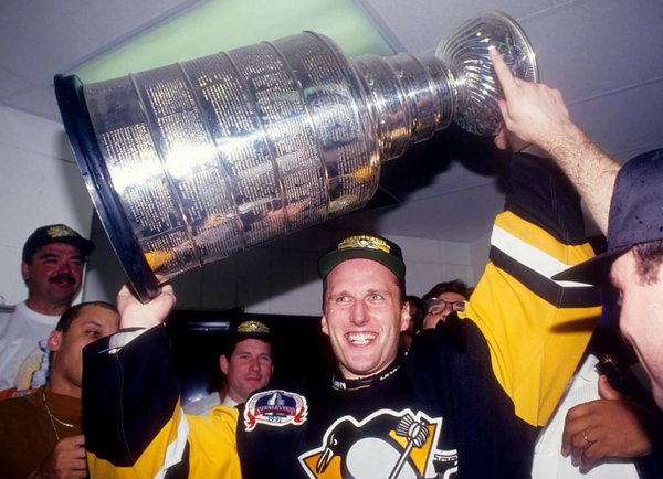 Photo of Pittsburgh Penguins goalie Tom Barrasso hoisting the Stanley Cup trophy in 1991. 