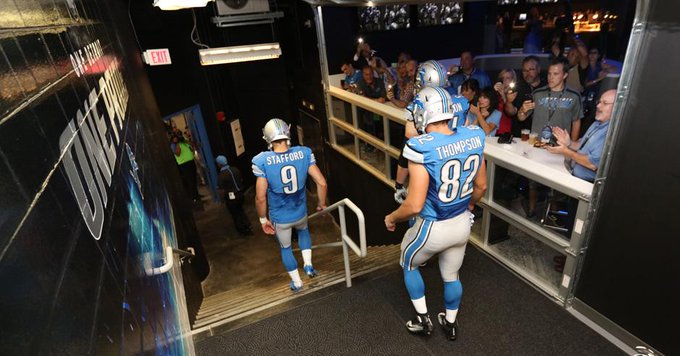 Photo of Detroit Lions players walking through the MGM Grand Tunnel Club at Ford Field.