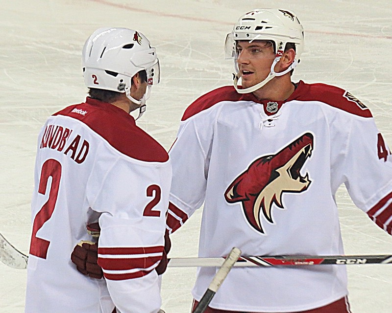 Photo of Arizona Coyotes players skating on the ice during a game.