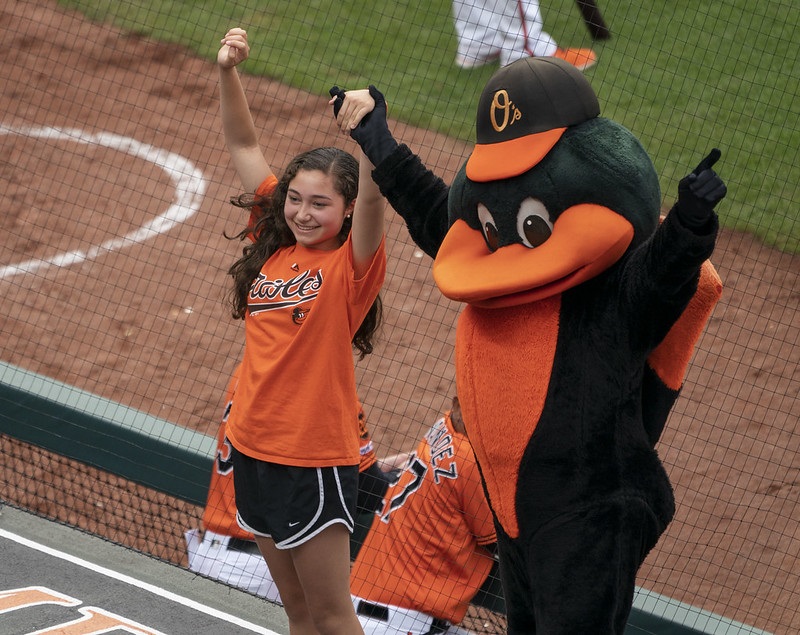 Photo of the Baltimore Orioles mascot with a young fan.