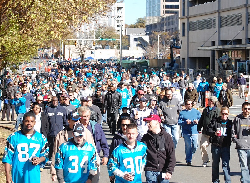 Photo of Carolina Panthers football fans walking outside of Bank of America Stadium.