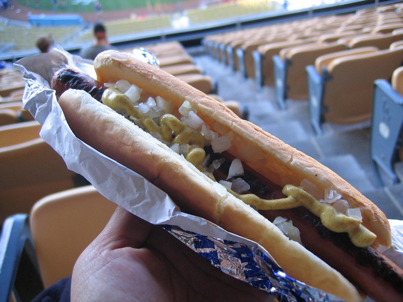 Photo of a baseball fan holding a Dodger Dog during a Los Angeles Dodgers game at Dodger Stadium.