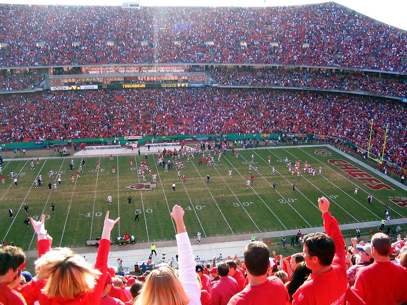 Photo of Kansas City Chiefs fans cheering at Arrowhead Stadium.