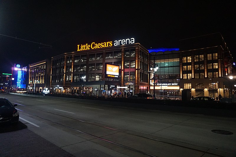 Exterior photo of Little Caesars Arena at night.