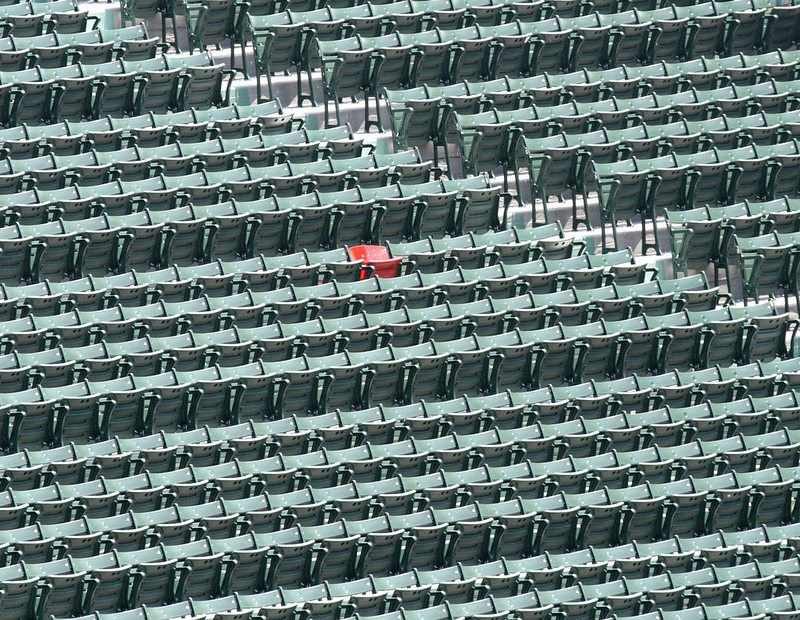 Photo of the lone red seat in the outfield bleachers of Fenway Park. Home of the Boston Red Sox.