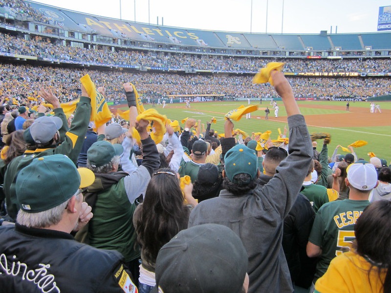 Photo of cheerful Oakland Athletics fans at Oakland Coliseum.