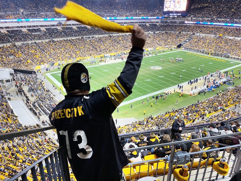 Photo of a Pittsburgh Steelers fan waving a yellow terrible towel at Heinz Field.