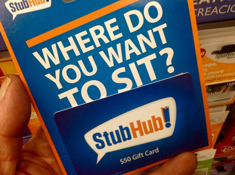 Photo of a man holding a StubHub gift card.