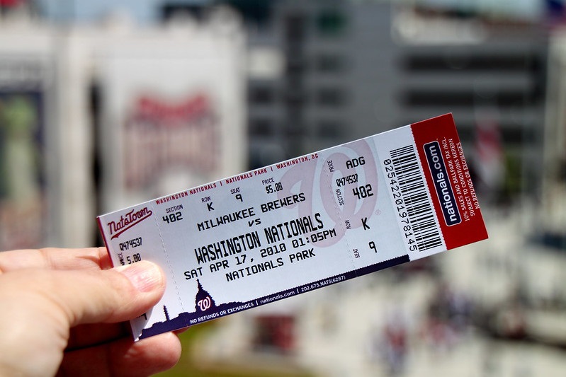 Photo of a ticket scalper holding Major League Baseball tickets outside of a stadium.