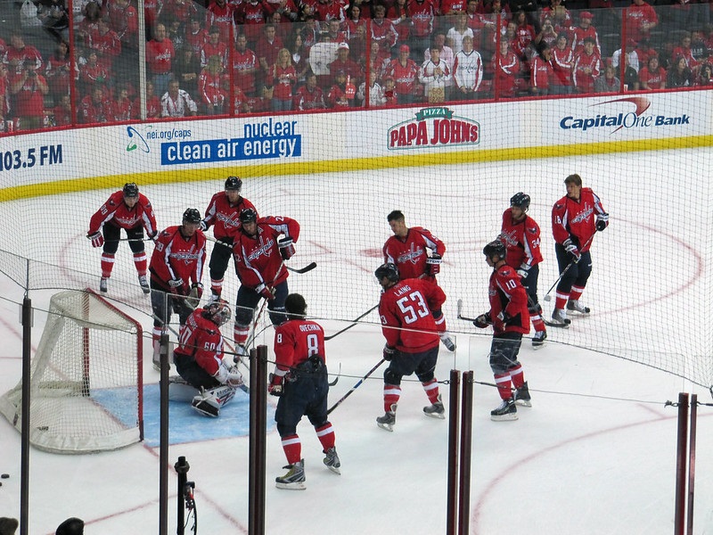 Photo of Washington Capitals players on the ice at Capital One Arena.