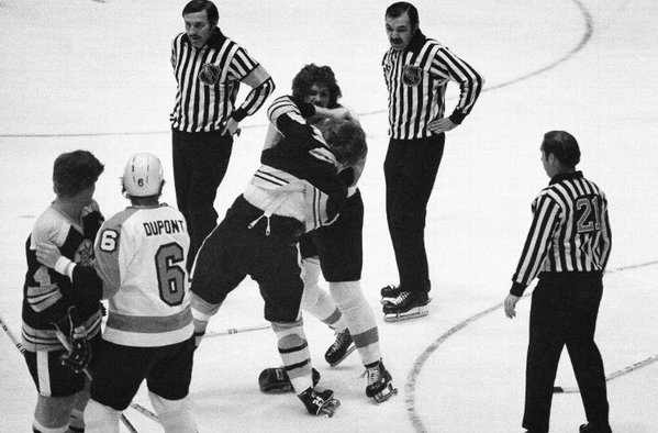 Black and white photo of Terry O'Reilly of the Boston Bruins fighting Dave Schulz of the Philadelphia Flyers.