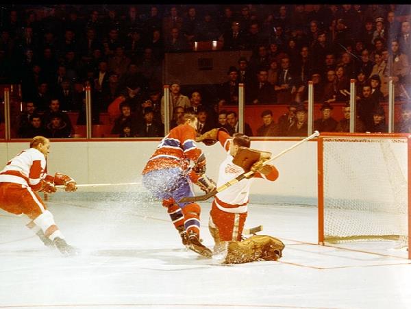 Photo of former Montreal Canadiens legend and center Jean Beliveau scoring on the Detroit Red Wings.