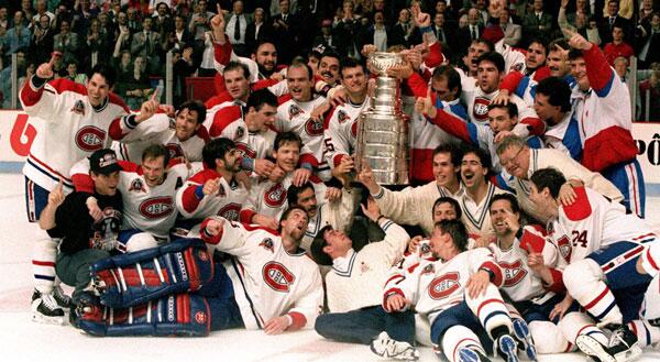 Old photo of the Montreal Canadiens hoisting the Stanley Cup.