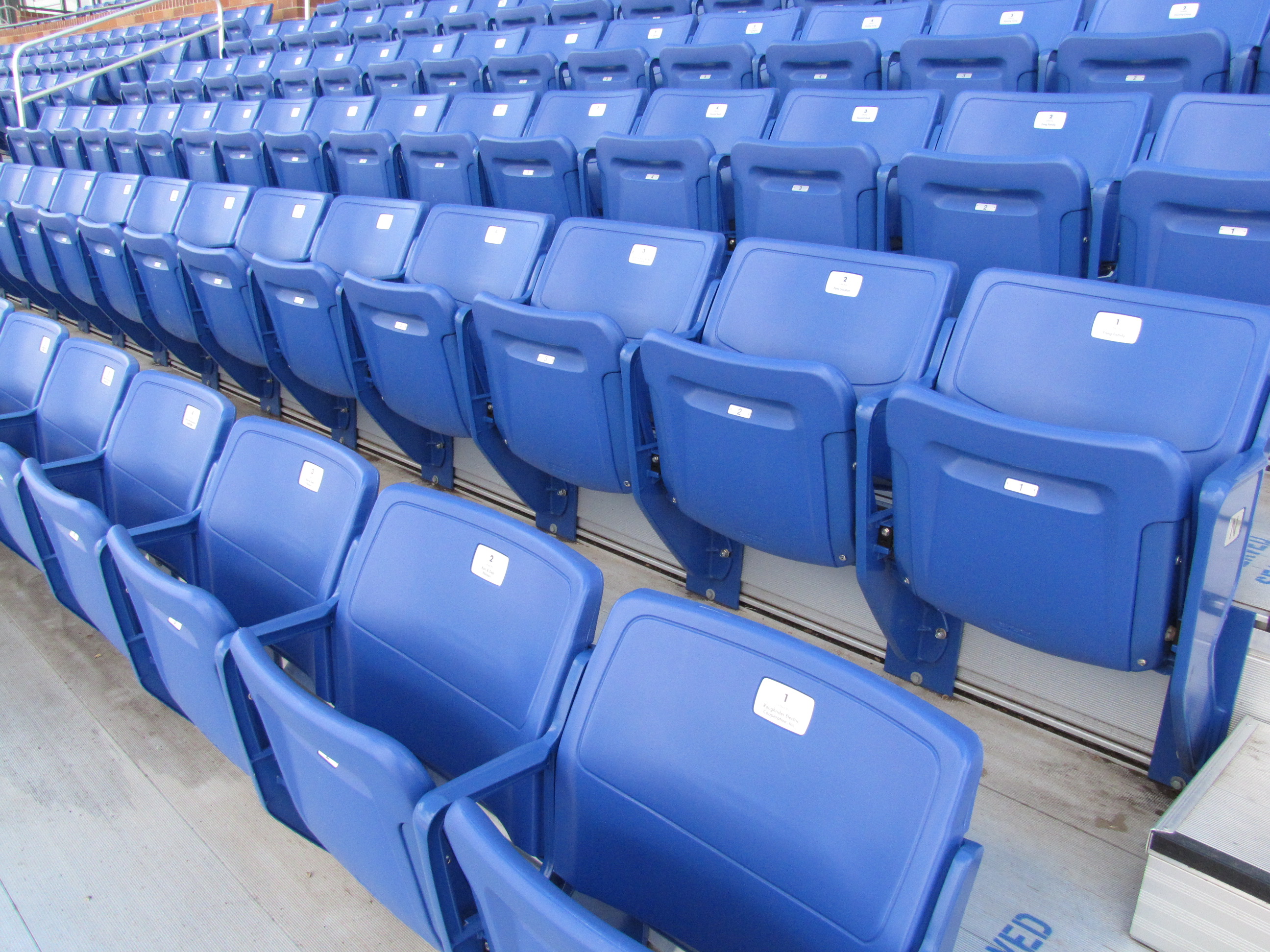 Stock photo of empty seats at an outdoor stadium.